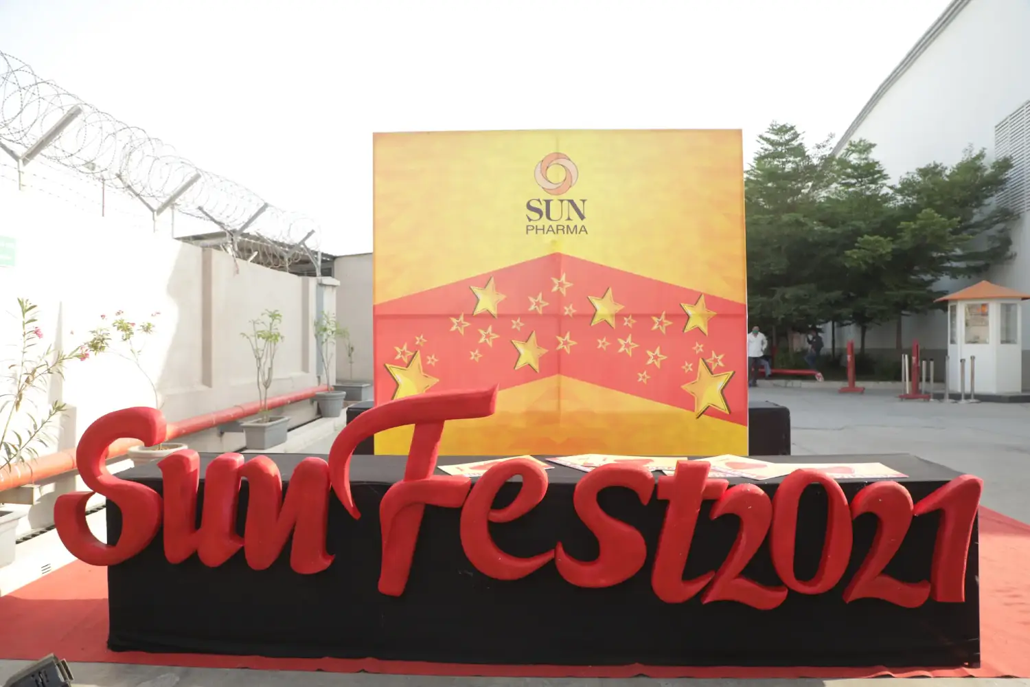 Man and woman speaking on stage at night with blue lighting